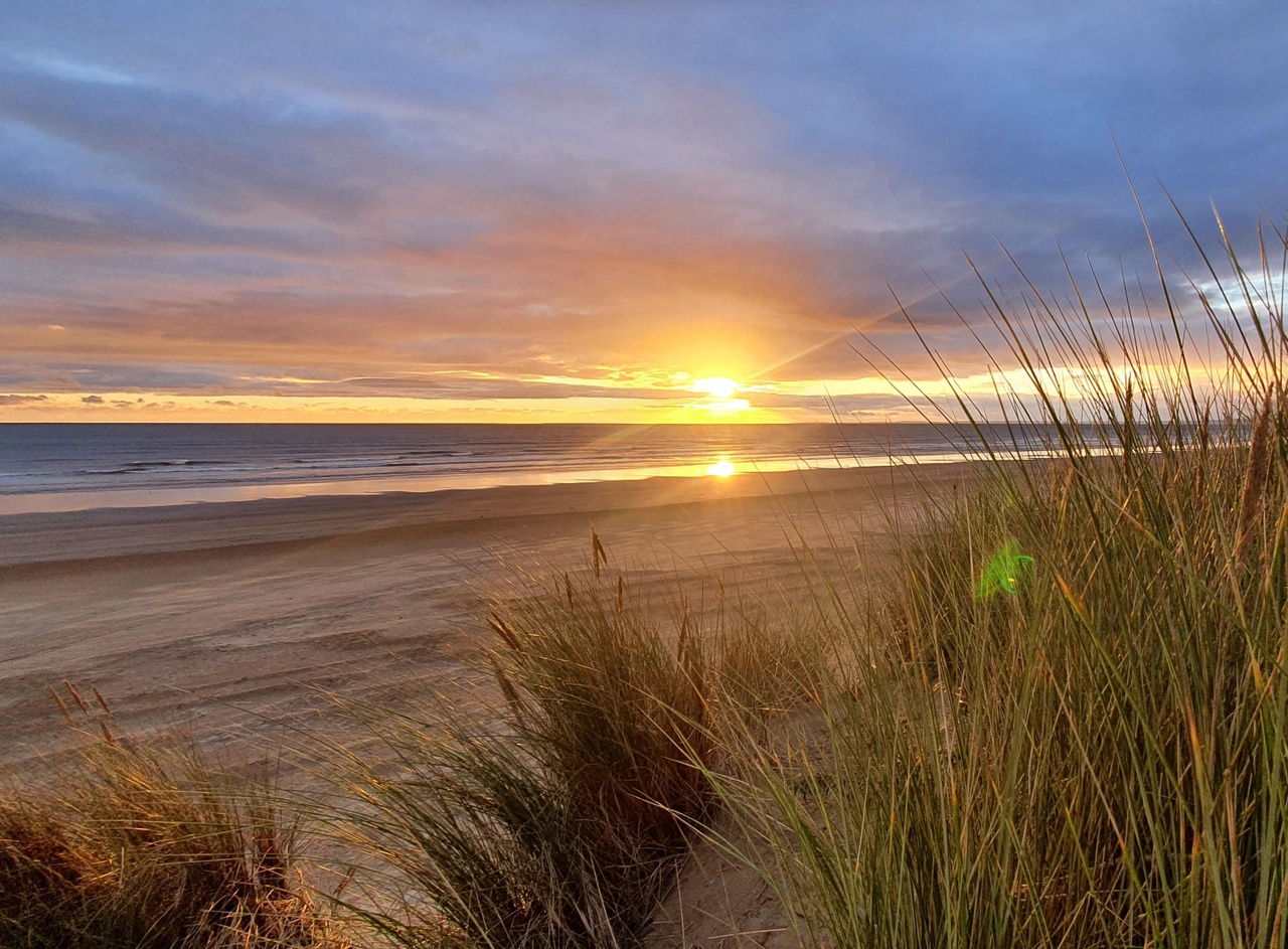 View of a sunrise from Ynys Enlli beach.