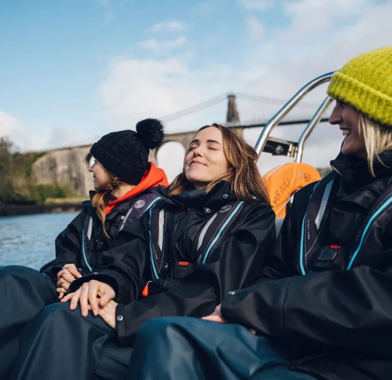 Grŵp o ferched yn mwynhau taith Rib Ride ar y Menai