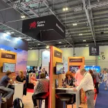People engaging at a Business Events exhibition.